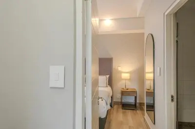 a hotel room with a bed and a mirror at Luxury 2BR Loft with Patio Near Menlyn at the Regency in Pretoria