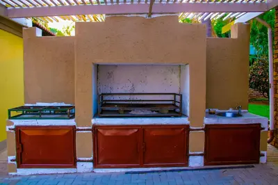 an outdoor kitchen with a stove and a sink at Maruleng Guest House in Hoedspruit