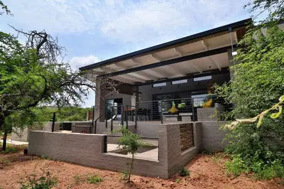 a modern house with a staircase in front of it at Umkhaya in Marloth Park