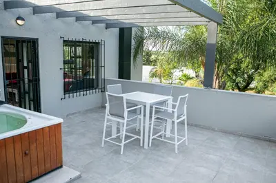 a porch with a table and chairs on a patio at Fair Glen in Kyalami