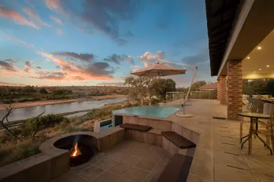 a patio with a plunge pool and a fire pit at Buffalo Brooke in Hectorspruit