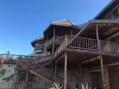 a large house with decks on the side of it at Boabab Lodge in Mabula