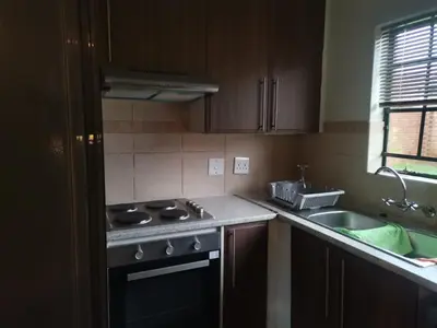 a kitchen with a stove and a sink at Centurion Cosy Apartment in Centurion
