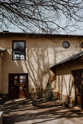 a house with a christmas tree in front of it at African Leaves Trout Lodge in Dullstroom