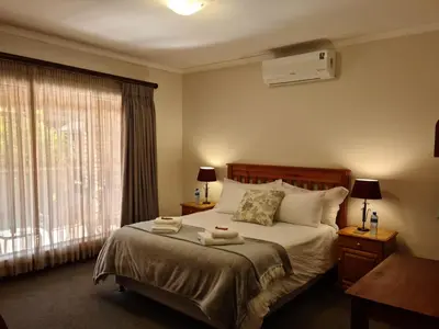 a bedroom with a bed with two towels on it at Hornbill Helipad 1 in Centurion