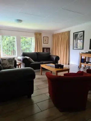 a living room with couches and a coffee table at Hornbill Helipad 1 in Centurion