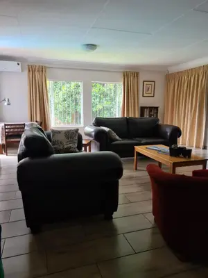 a living room with two couches and a coffee table at Hornbill Helipad 1 in Centurion