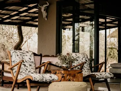 two chairs sitting on a porch with a table at Maroelani Lodge- Greater Kruger Private Reserve in Hoedspruit