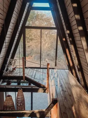 a room with a large window in a building at Shepherds Rest in Hoedspruit