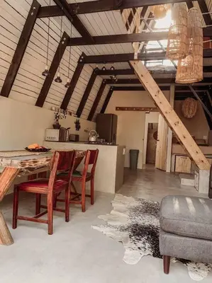 a kitchen with a table and chairs in a room at Shepherds Rest in Hoedspruit