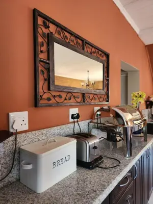 a hair salon with a mirror and a hair dryer at SOUTHY INN BY THE LAKE in Benoni