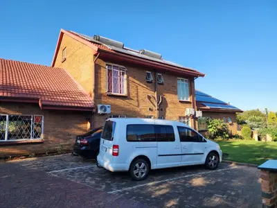 a white van parked in front of a house at SOUTHY INN BY THE LAKE in Benoni