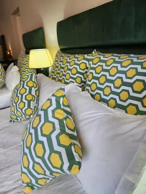 a bed with pillows and a lamp on it at SOUTHY INN BY THE LAKE in Benoni