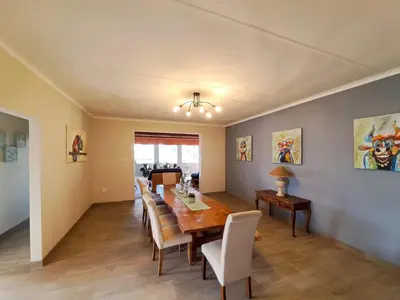 a dining room with a table and chairs at The Outpost Dullstroom in Dullstroom