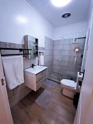 a bathroom with a sink and a toilet at The Outpost Dullstroom in Dullstroom