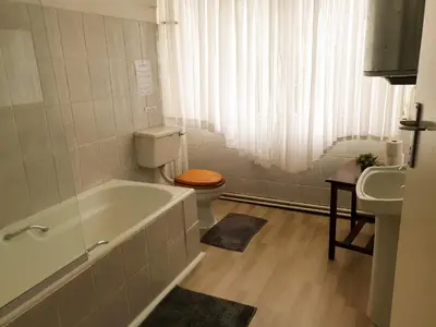 a bathroom with a tub and a toilet and a sink at The Outpost Dullstroom in Dullstroom