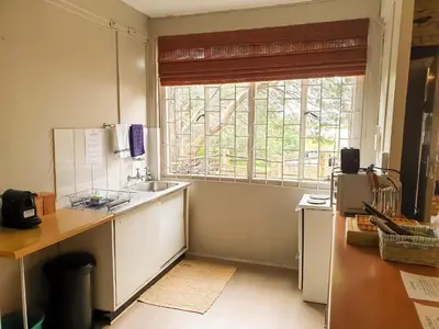 a kitchen with a sink and a window at The Outpost Dullstroom in Dullstroom