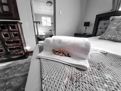 a bedroom with a bed with a towel on it at The Outpost Dullstroom in Dullstroom