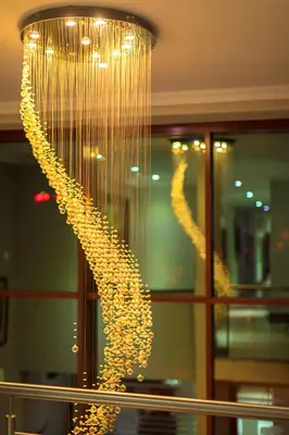 a large chandelier with gold chains hanging from it at The Pillows Suite in Pretoria