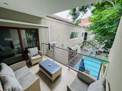 a balcony with a view of a swimming pool at The Pillows Suite in Pretoria