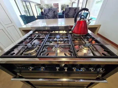 a stove top oven with a tea kettle on it at No 16 Elements - 5 Bedroom Beauty in Moheme