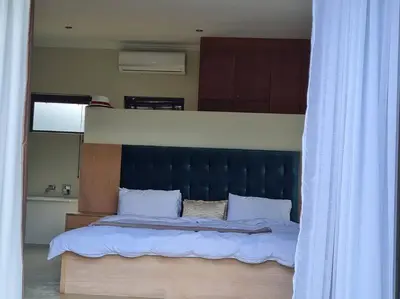 a bed with a black headboard in a bedroom at No 16 Elements - 5 Bedroom Beauty in Moheme