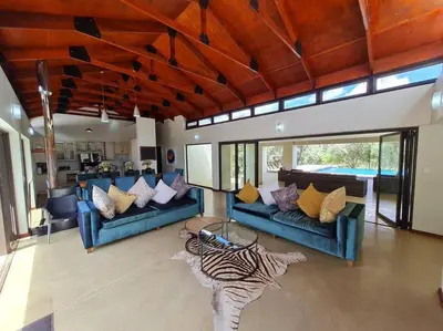 a living room with two blue couches and a zebra table at No 16 Elements - 5 Bedroom Beauty in Moheme