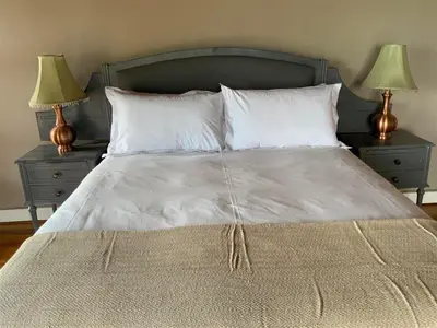 a large bed with two nightstands and two lamps at Marina Views Guesthouse in Hartbeespoort