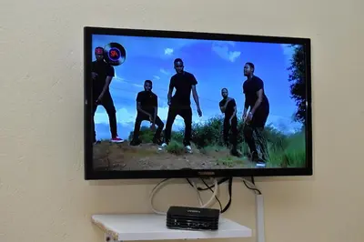 a television screen with a group of men on it at LEMEK Heights in Ga-Mothiba