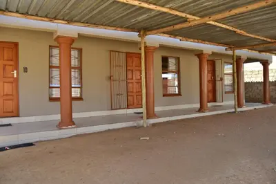 an empty building with wooden columns and windows at LEMEK Heights in Ga-Mothiba