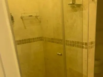a shower with a glass door in a bathroom at 131 on Herbert Baker Boutique Hotel in Pretoria