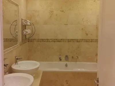 a bathroom with a sink and a toilet and a tub at 131 on Herbert Baker Boutique Hotel in Pretoria