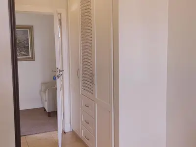 a hallway with a door leading to a living room at 131 on Herbert Baker Boutique Hotel in Pretoria