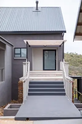 a house with stairs leading to the front door at Elements Sunrise Bush Lodge in Bela-Bela