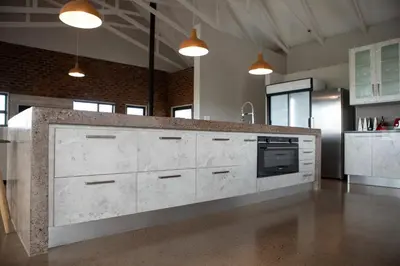 a kitchen with white cabinets and a counter top at Elements Sunrise Bush Lodge in Bela-Bela