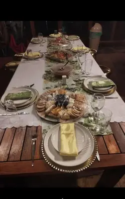 a wooden table with plates of food on it at Livingstone Bush Lodge, Mabalingwe in Bela-Bela