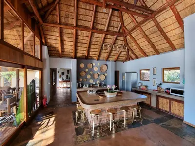 a kitchen with a large wooden table and chairs at Livingstone Bush Lodge, Mabalingwe in Bela-Bela