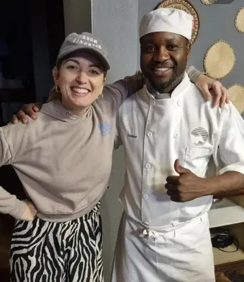 a man and a woman standing in a kitchen at Livingstone Bush Lodge, Mabalingwe in Bela-Bela
