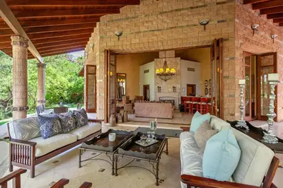 a living room with a couch and a table at Lejwe La Metsi Private Reserve in Bela-Bela