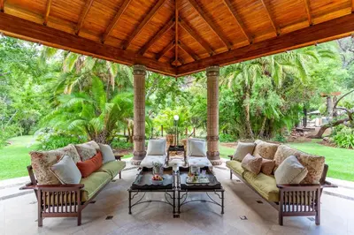 a porch with two couches and a table at Lejwe La Metsi Private Reserve in Bela-Bela