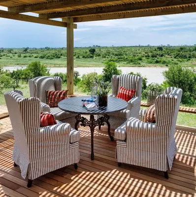 a patio with a table and chairs on a deck at Ukuthula House in Hectorspruit