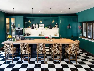 a kitchen with green walls and a large table with chairs at Ukuthula House in Hectorspruit