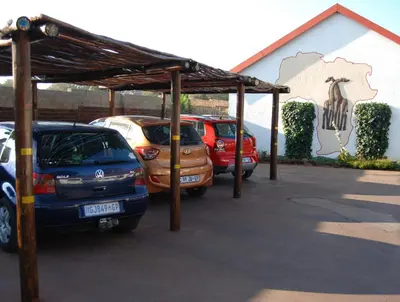 a group of cars parked in a parking lot at Journey's Inn Africa Guest Lodge in Kempton Park