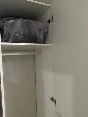 a closet with a white door and a shelf at liam travel inn in Nelspruit