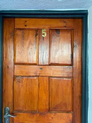 a wooden door with the number on it at liam travel inn in Nelspruit