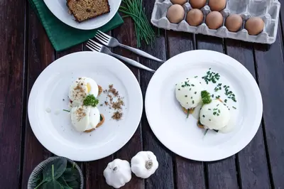 two plates of food on a table with eggs at Nungubane Game Lodge in Welgevonden Game Reserve