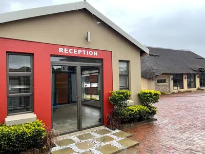 a red and tan building with a red door at Ko-Khoneng Guest house in Lebowakgomo