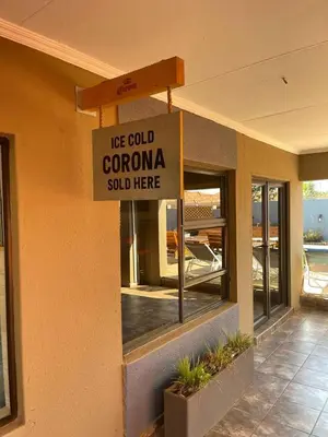a ice cold corona sold here sign on a building at Ko-Khoneng Guest house in Lebowakgomo