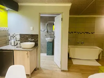 a bathroom with a tub and a sink at Ko-Khoneng Guest house in Lebowakgomo