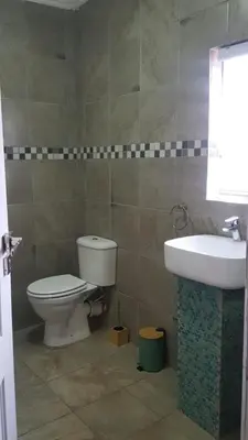 a bathroom with a toilet and a sink at Ko-Khoneng Guest house in Lebowakgomo